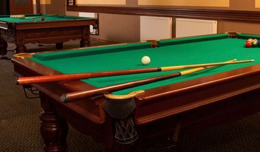 Billiard table with cues