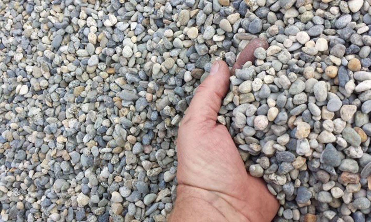 a pile of small, smooth, multi-colored pea rocks