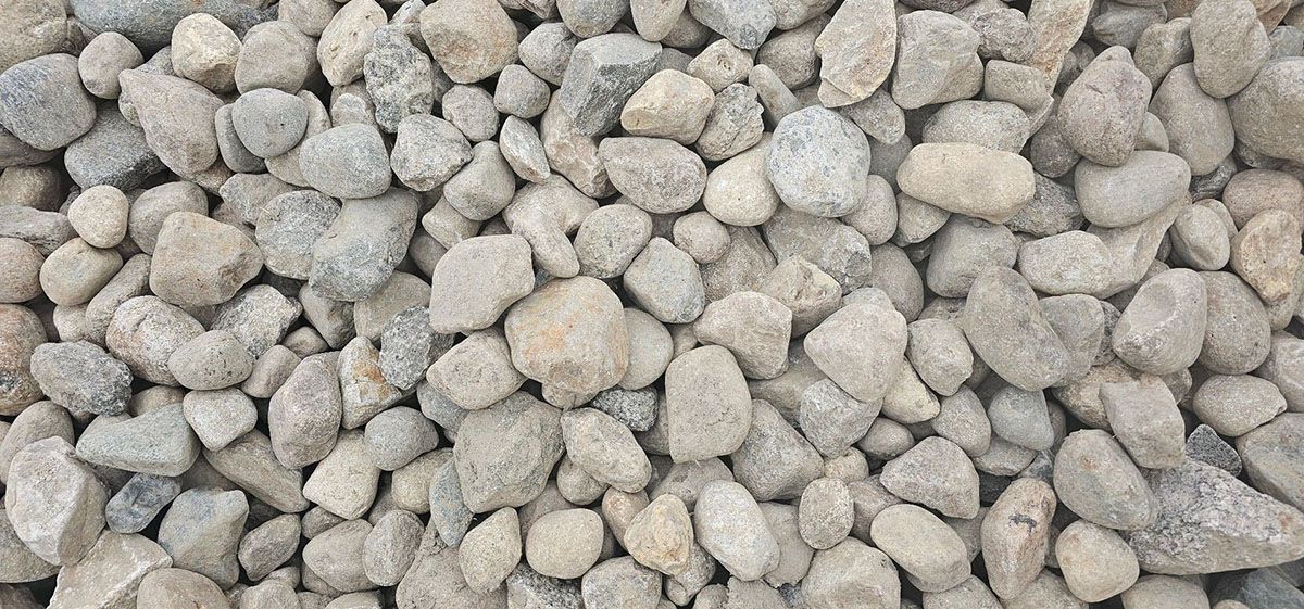 A dense, top-down view of light-colored river rock