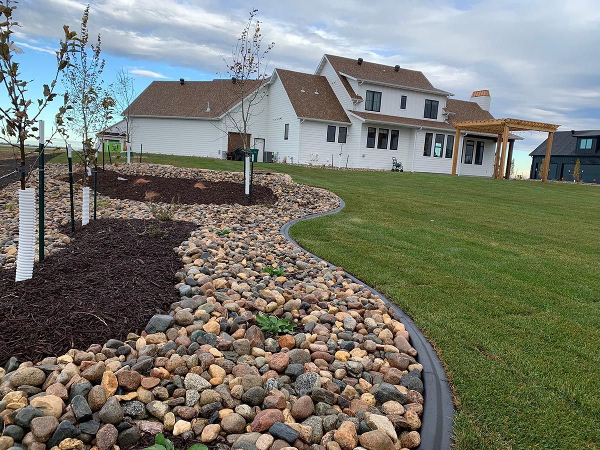 A landscaped yard with a curved rock bed