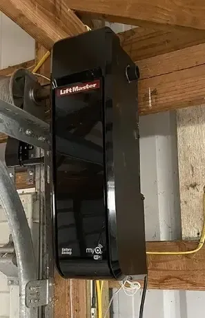 Black Lifebreath HVAC unit mounted on wooden framing in an attic or utility space