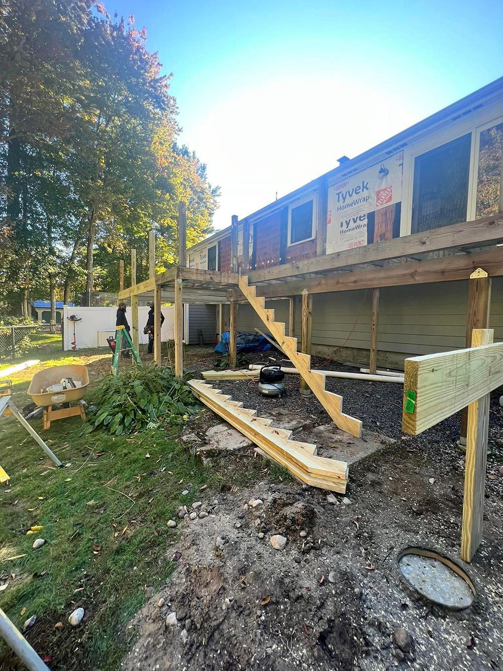 A wooden deck is being built on the side of a house