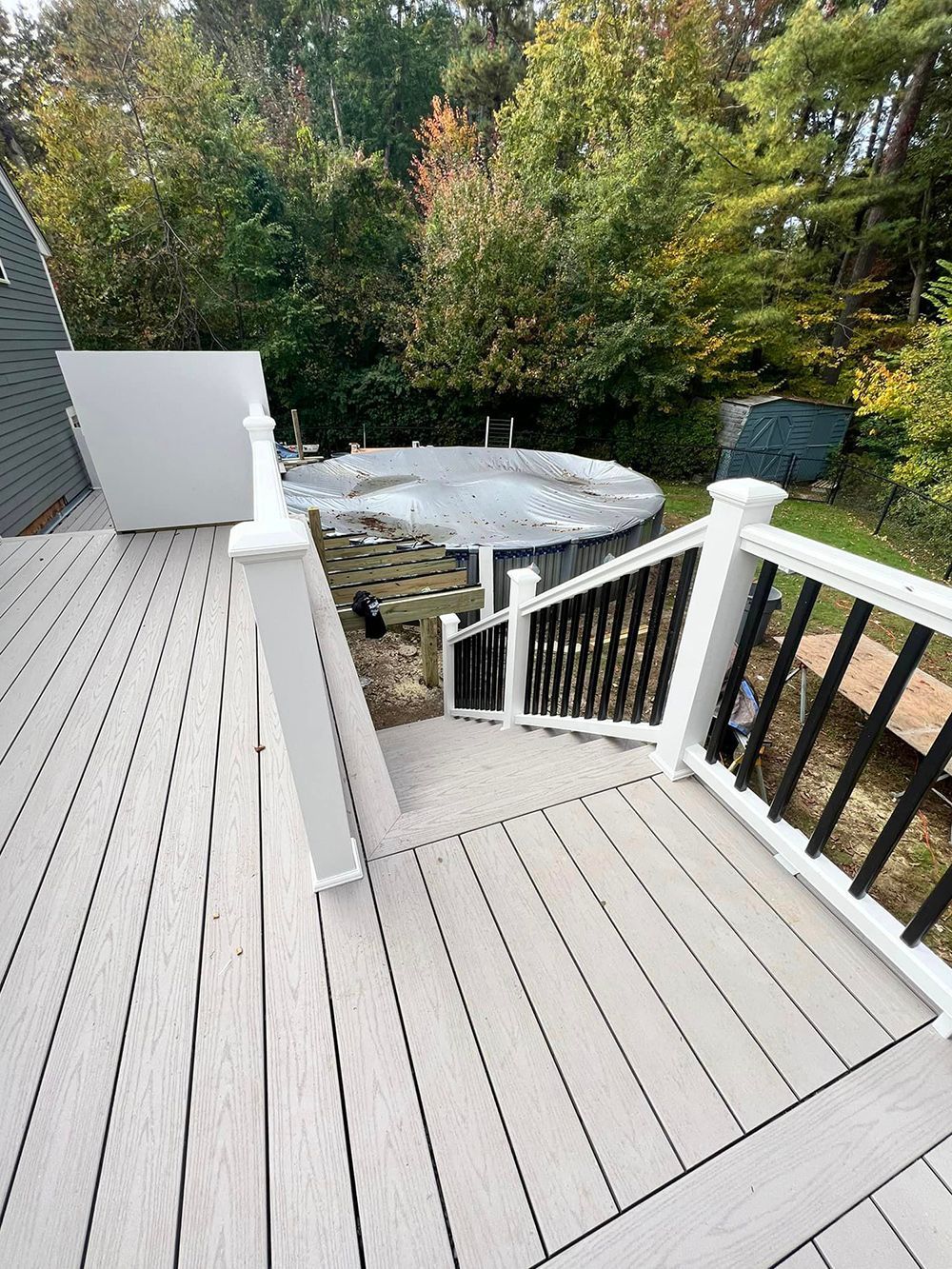 A deck with stairs leading up to a pool