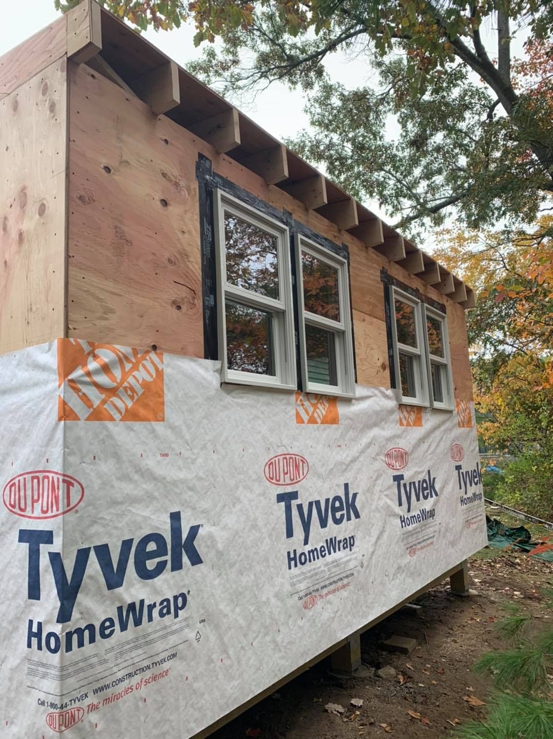 A small white house with a window being built