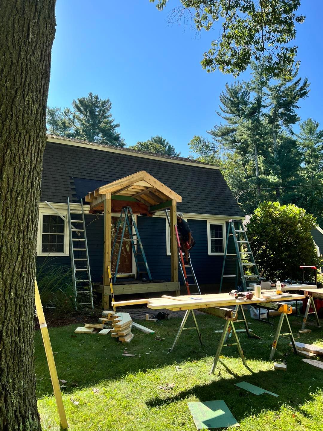 A house is being remodeled with a porch being built in the backyard
