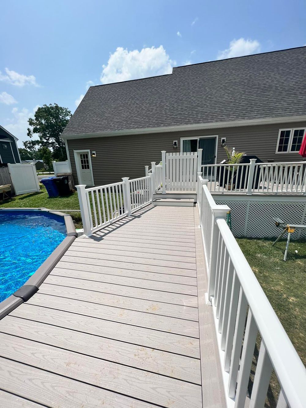 A house with a swimming pool and a deck leading to it