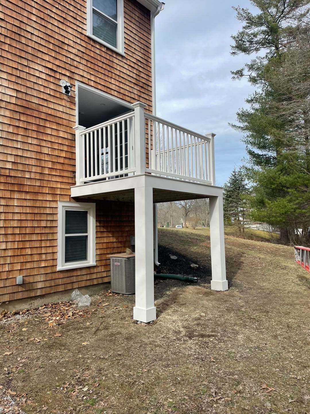 A house with a balcony on the side of it