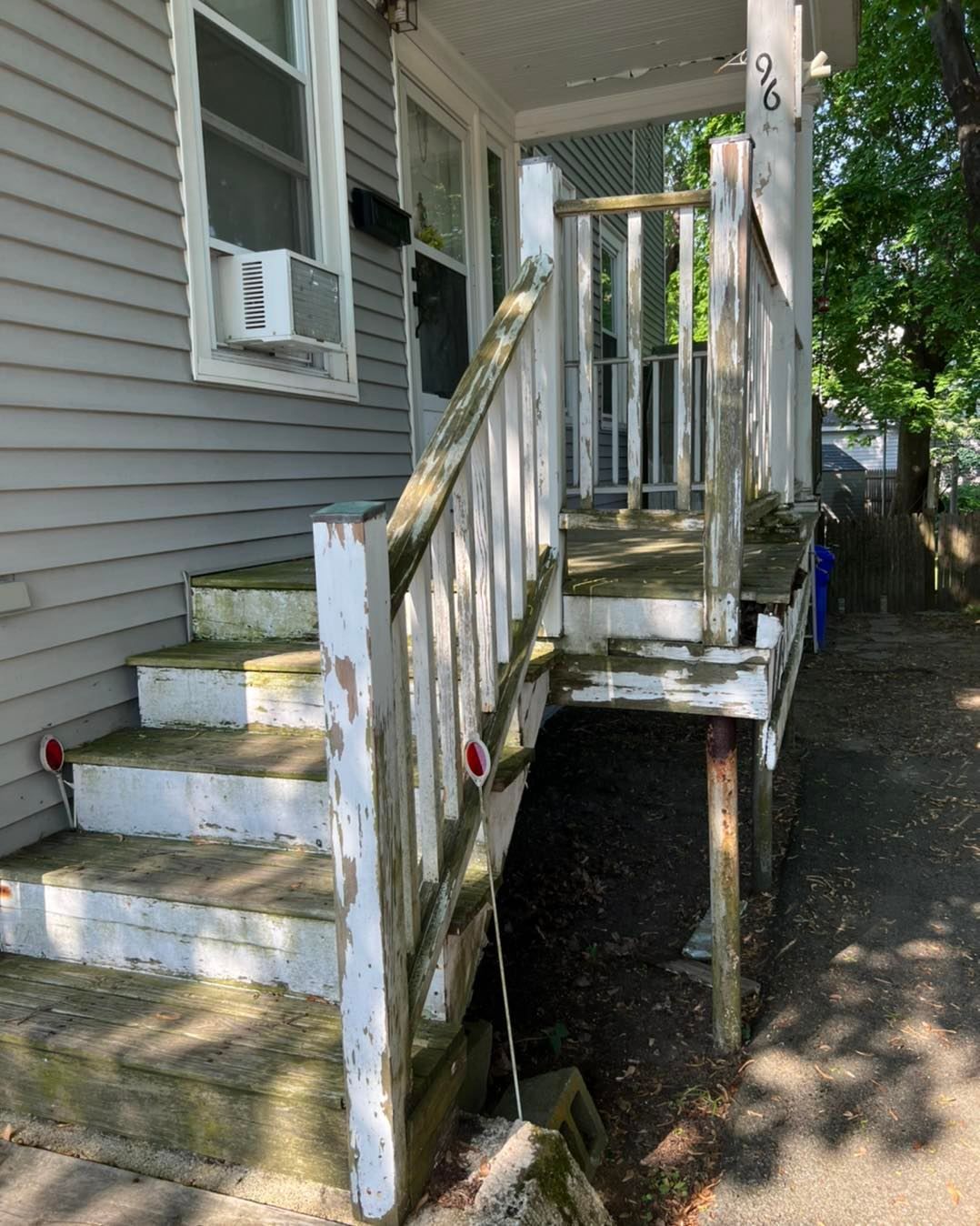 A house with stairs leading up to the front door