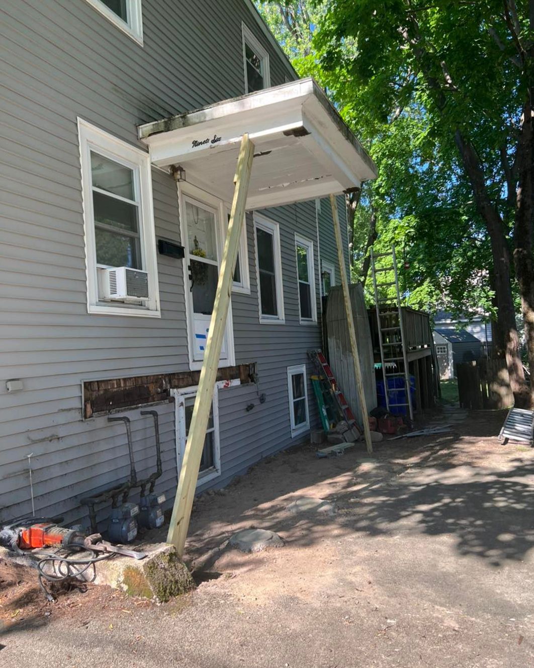 A house with a canopy over the front door is being remodeled