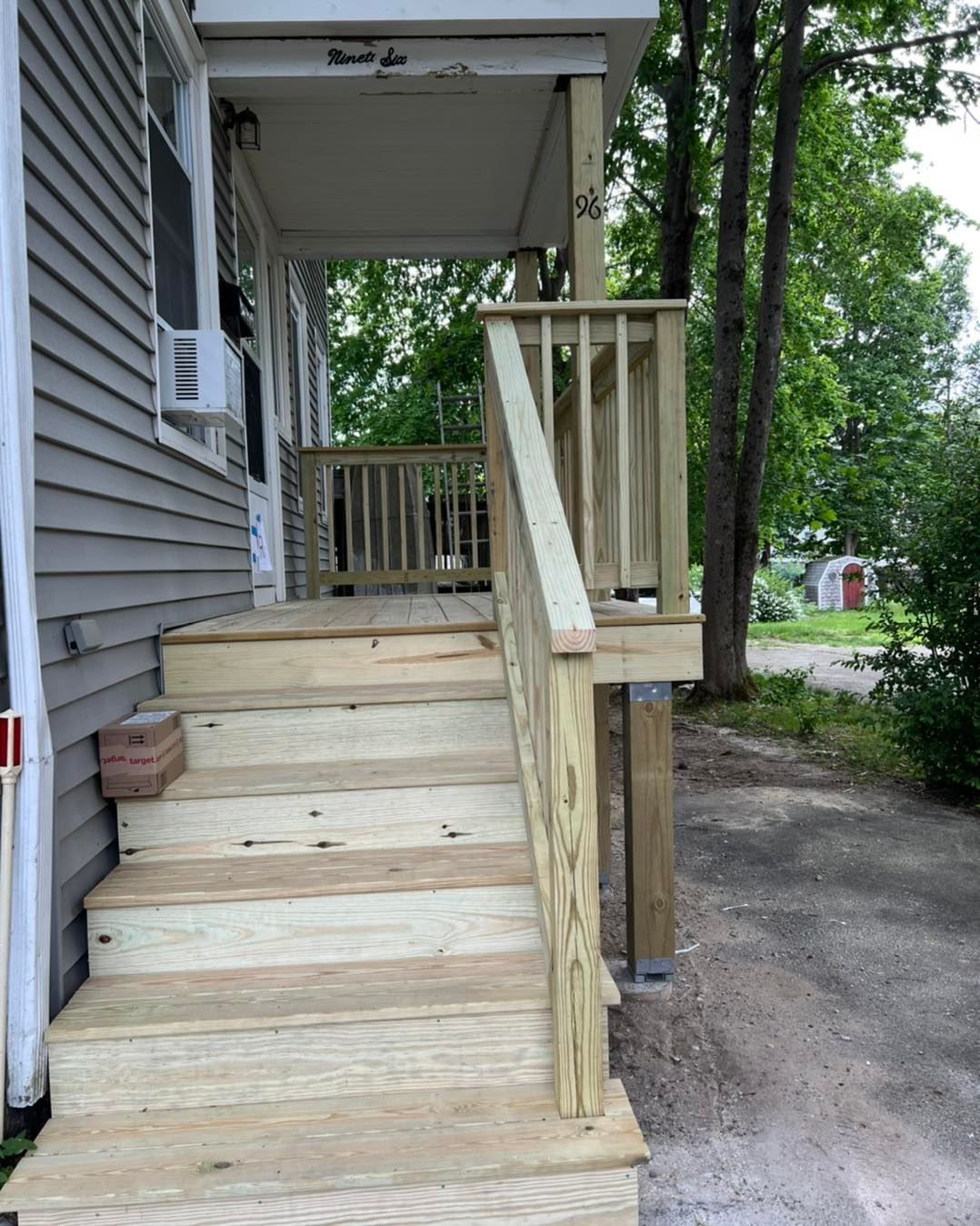 A wooden porch with stairs leading up to it
