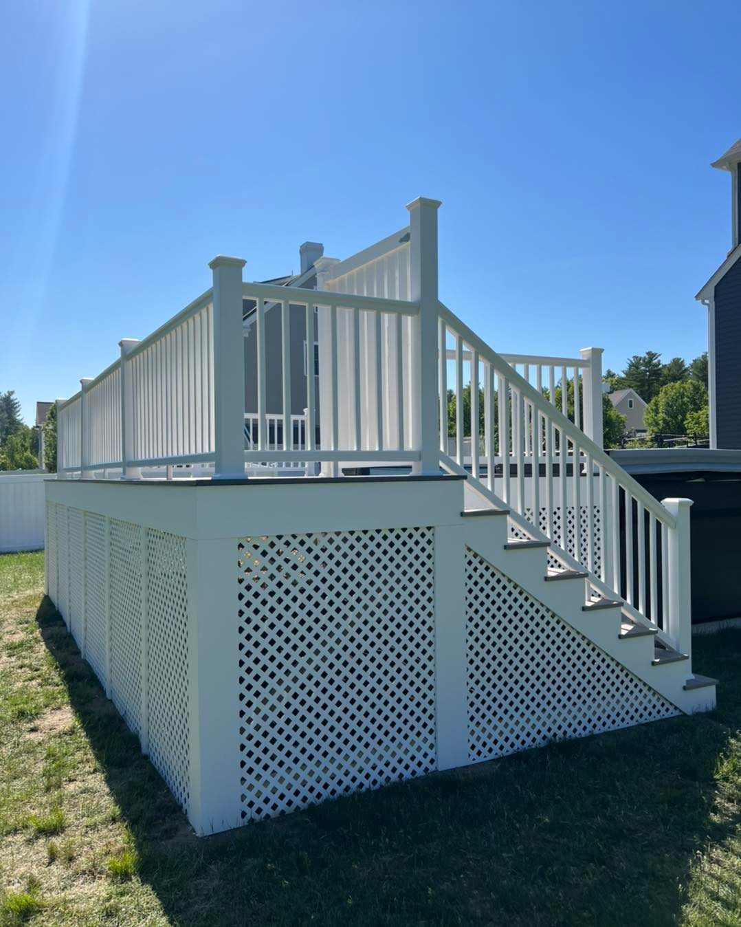 A white deck with stairs leading up to it