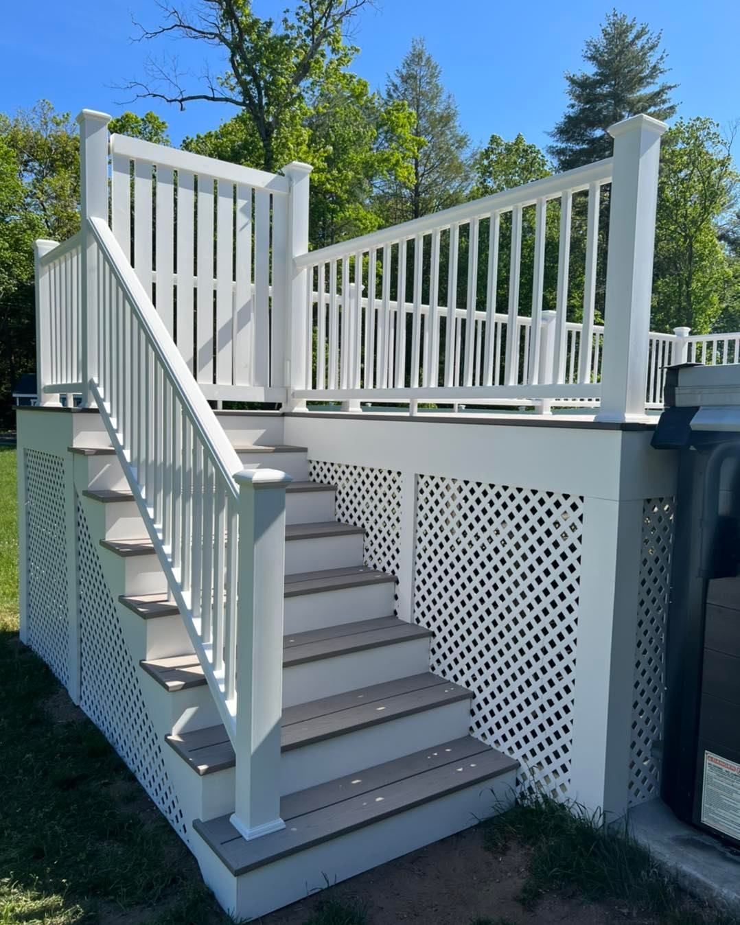A white deck with stairs leading up to it
