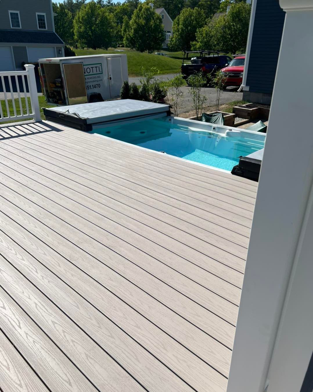 A deck with a pool and a hot tub on it