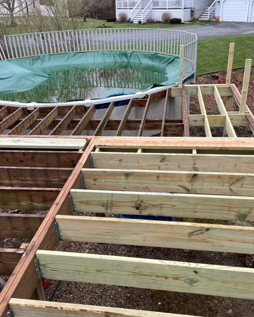A wooden deck is being built next to a swimming pool