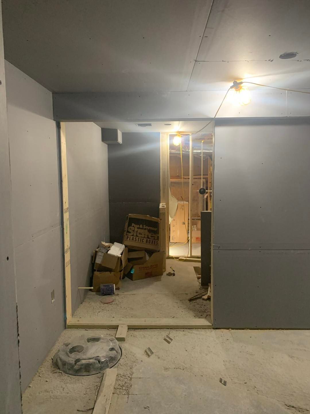 A room with a lot of boxes on the floor and a door