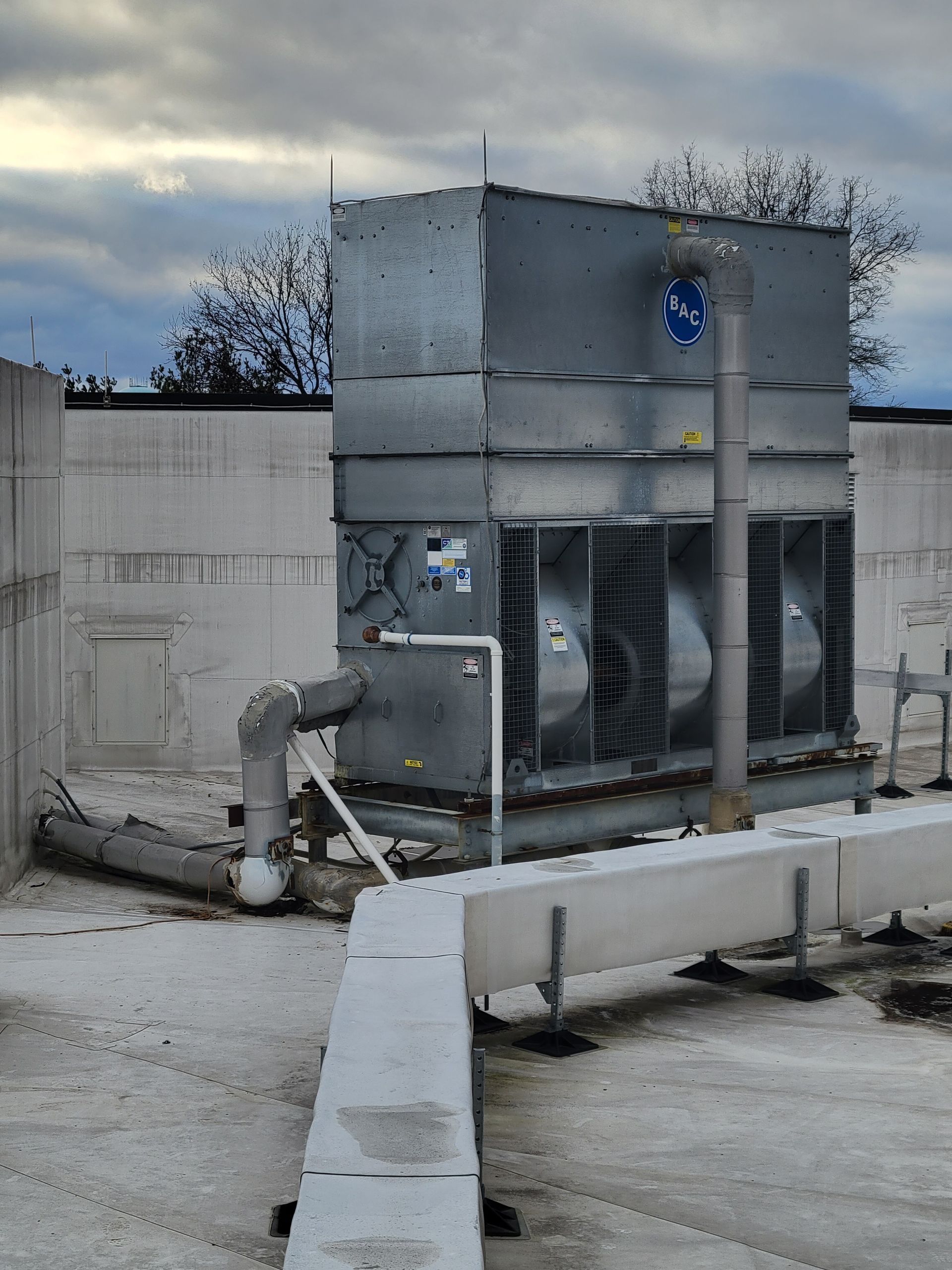 A large metal building with a lot of pipes attached to it