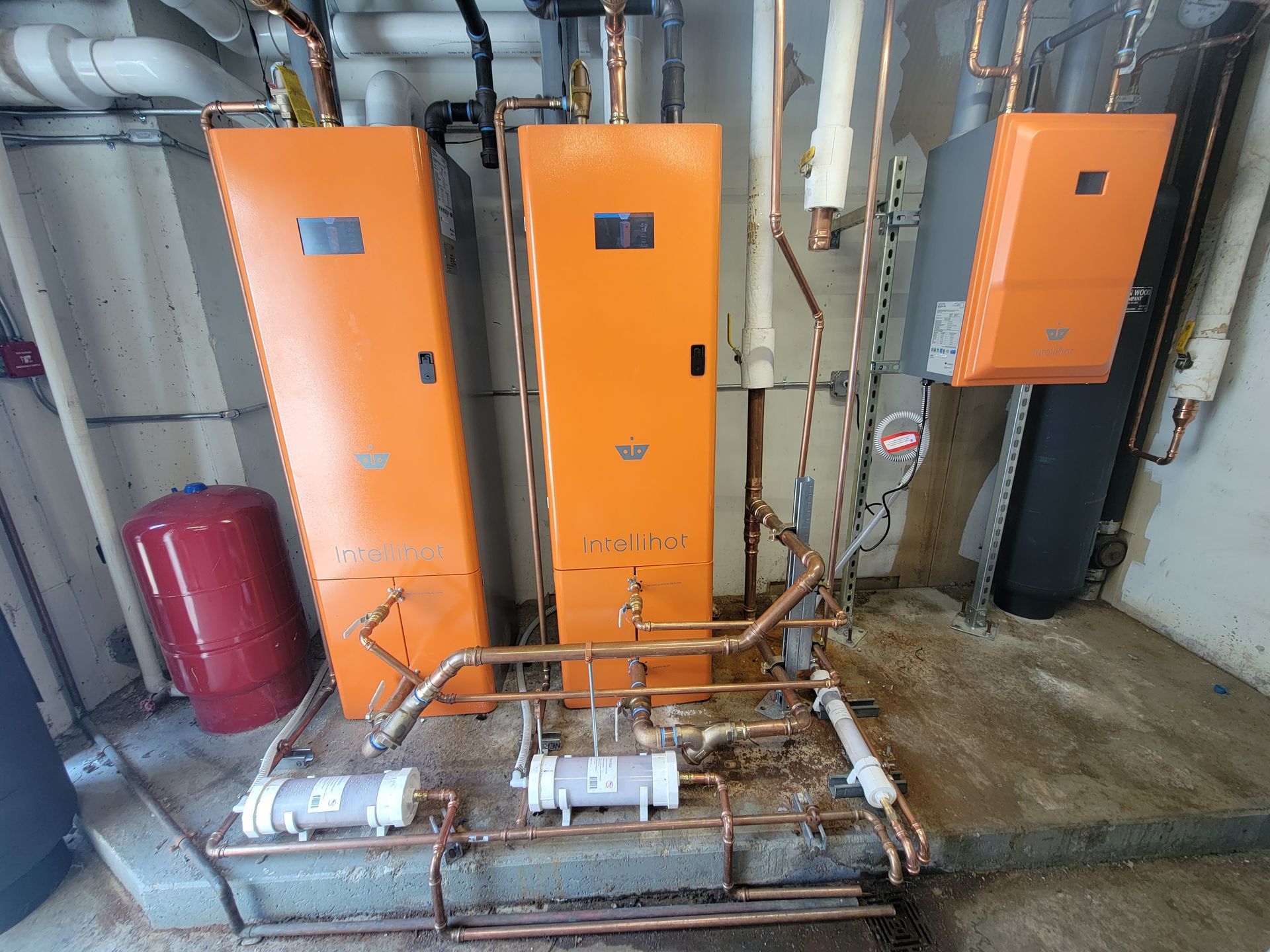 A room with three orange boxes and copper pipes