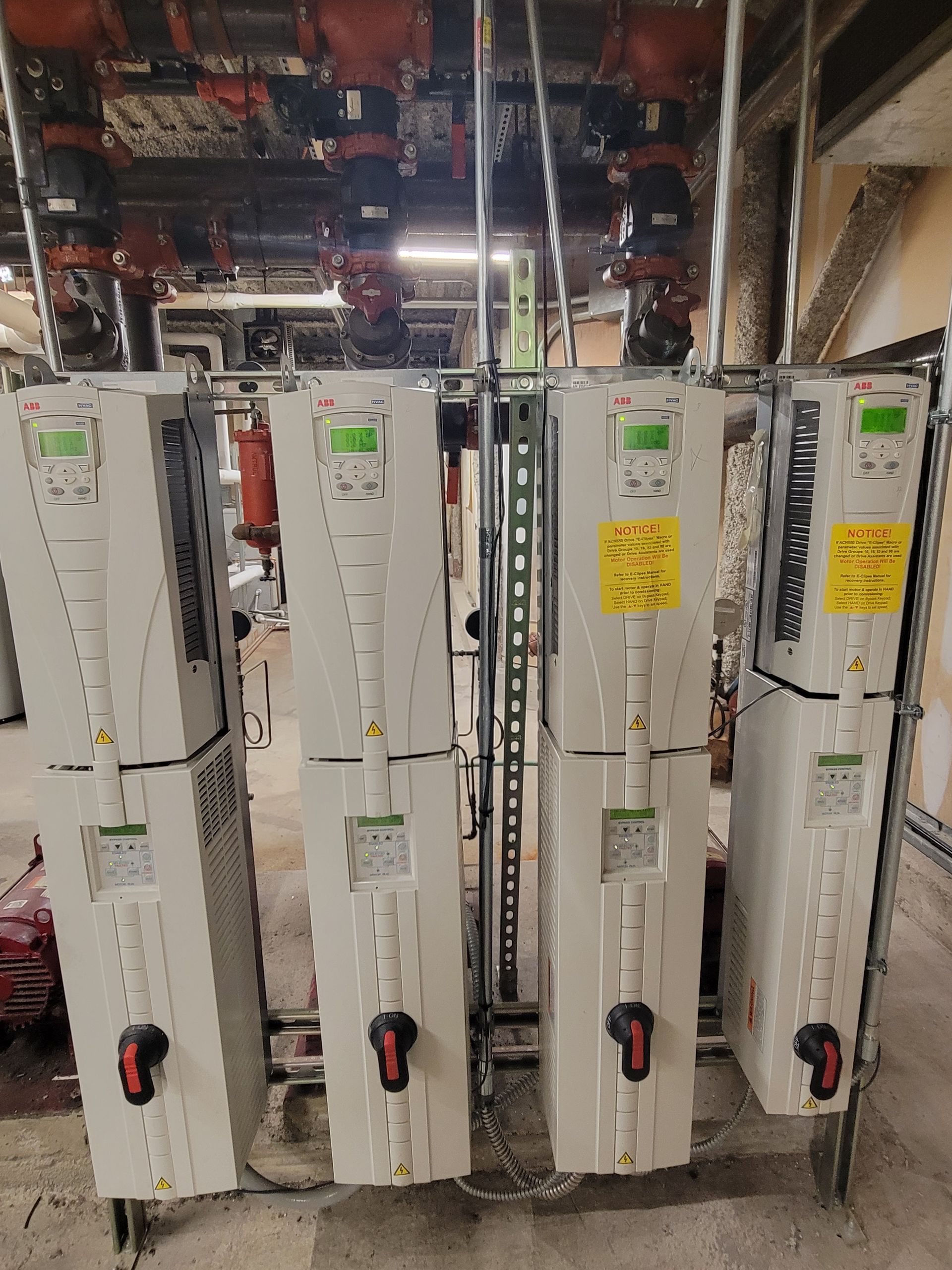 A row of electrical boxes sitting next to each other in a room.