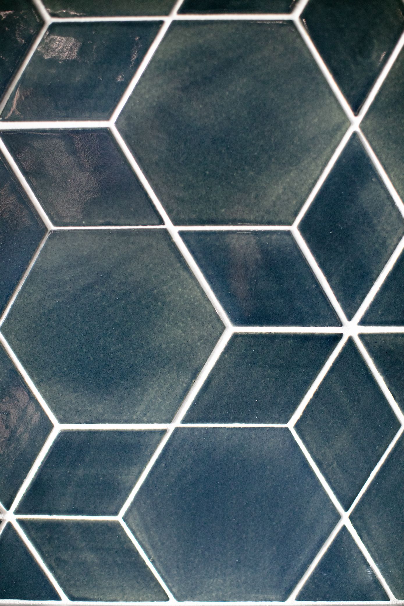 Dark blue hexagonal tiles with white grout create a geometric pattern.