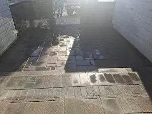 A brick walkway with steps leading up to a house.