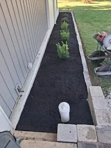 A sidewalk is being built in front of a house.