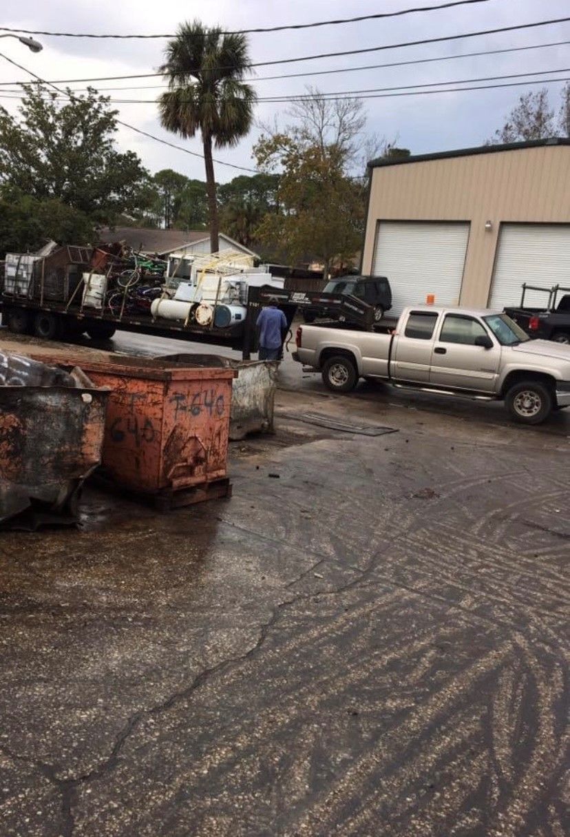 A row of trucks are parked in a parking lot in front of a building