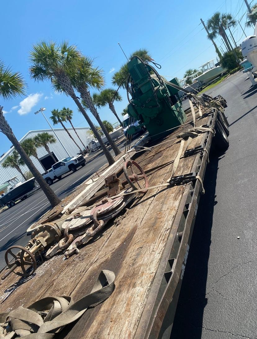 A flatbed truck is parked on the side of the road
