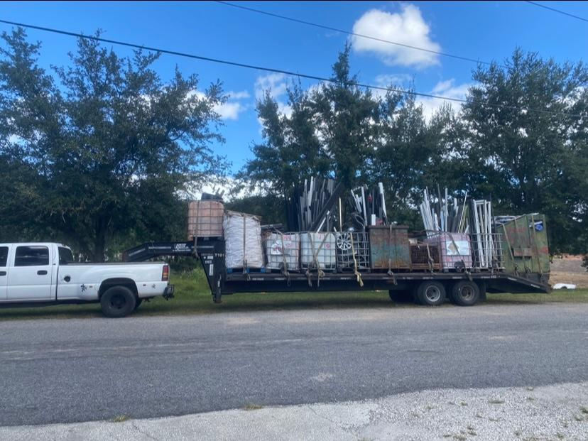 A white truck is pulling a trailer full of boxes