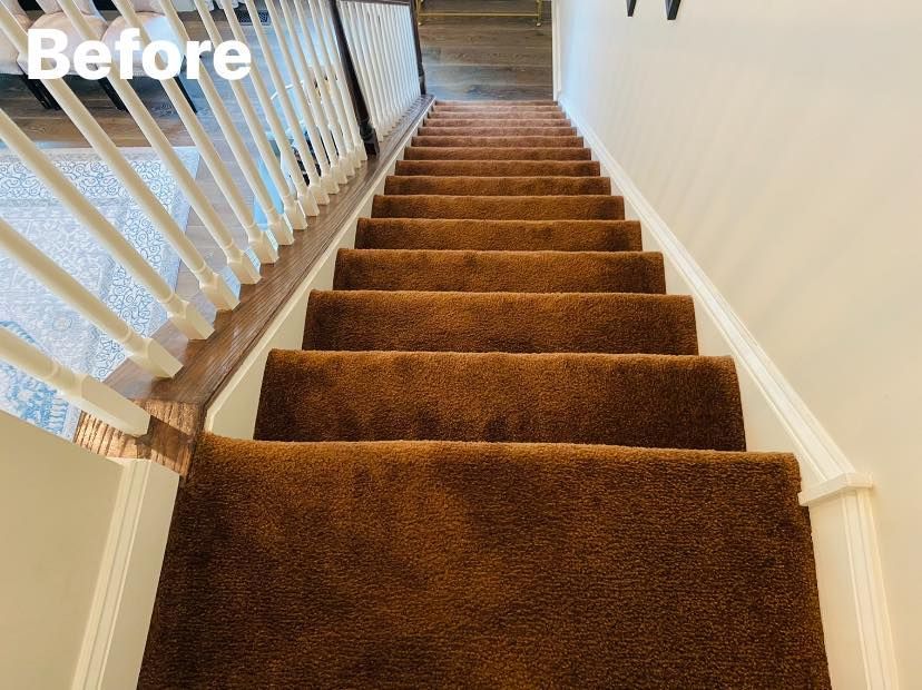 Brown carpeted staircase with white banister and trim. 