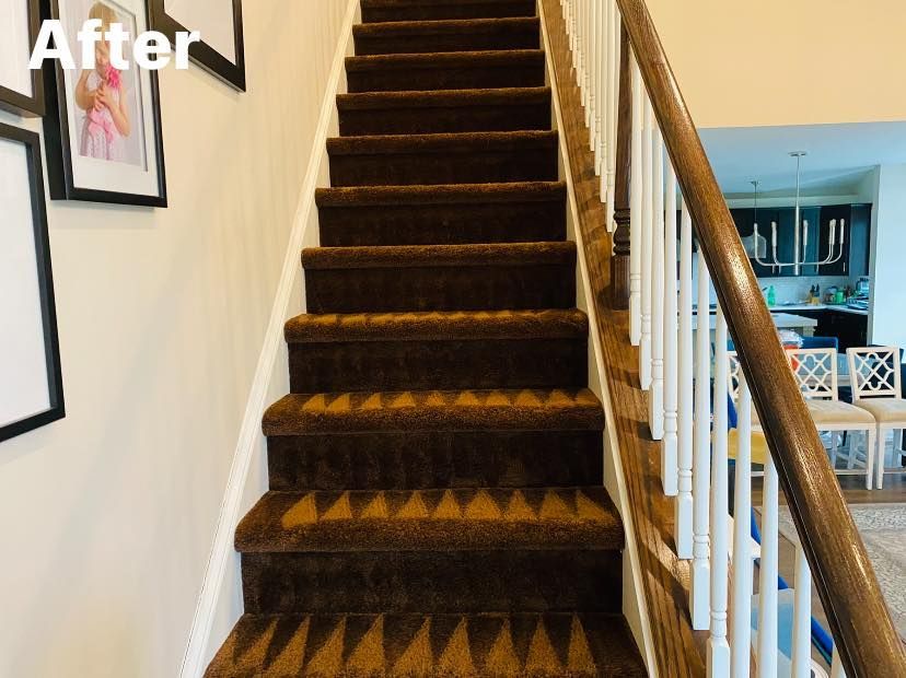 Brown carpeted staircase with white trim and railing, view from below.