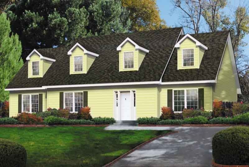 A yellow house with a brown roof and white trim
