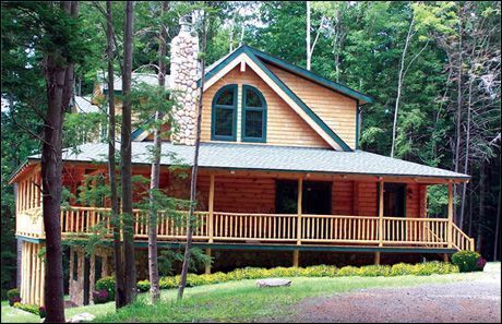 A large log cabin in the middle of a forest
