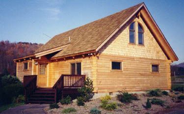 A small wooden house with a roof and stairs