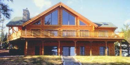 A large wooden house with a lot of windows and a large deck.