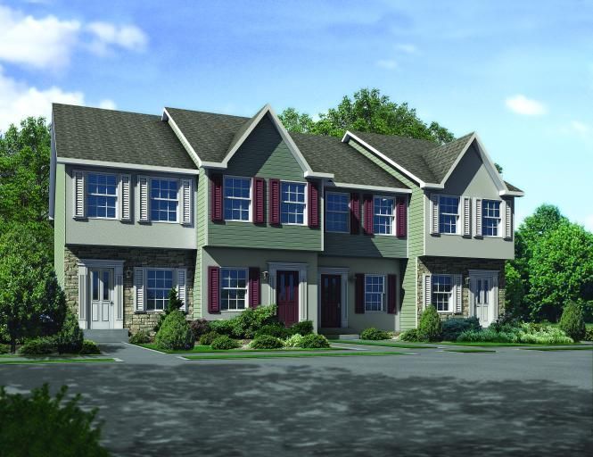 A house with a lot of windows and red shutters