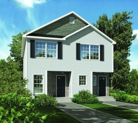 A white house with a green roof and black shutters