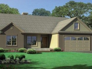 A house with a garage and a large lawn in front of it