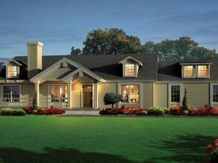 A large house with a lush green lawn in front of it