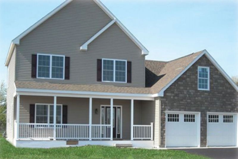 A house with a porch and two garage doors