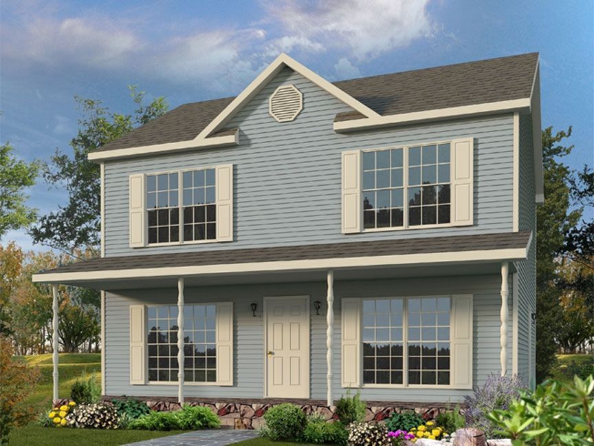 A blue house with a porch and lots of windows