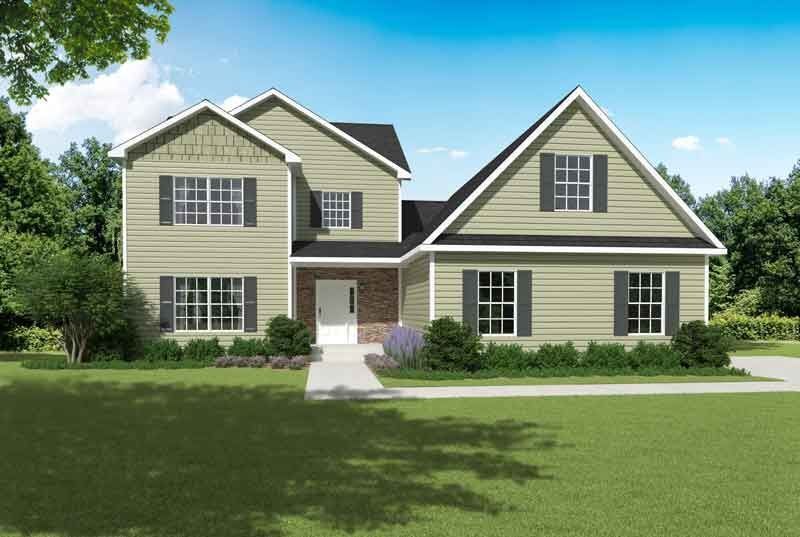 A large house with a lot of windows and a black roof is sitting on top of a lush green lawn.