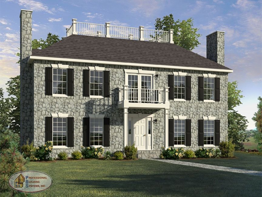 A large stone house with black shutters and a balcony