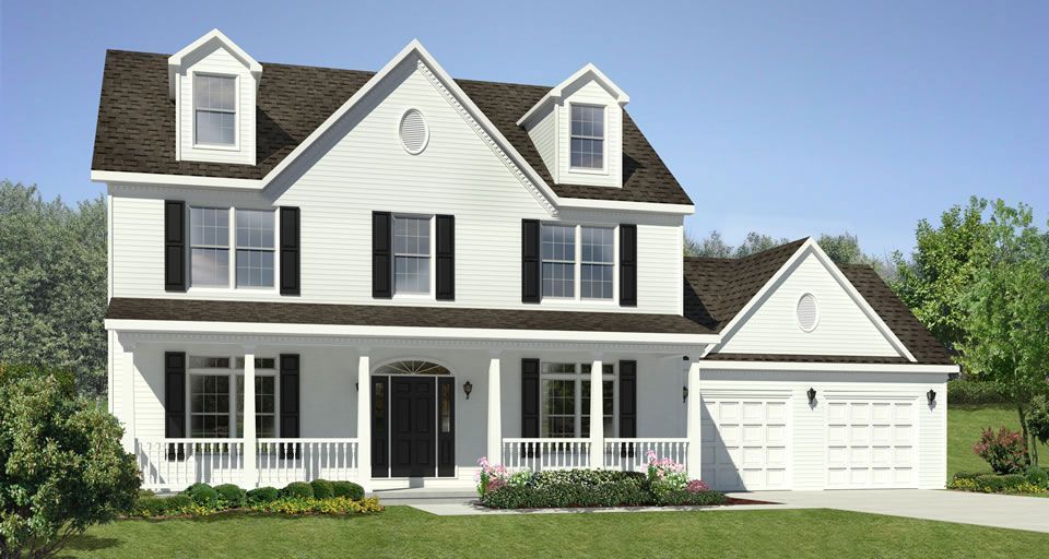 A large white house with a brown roof and black shutters