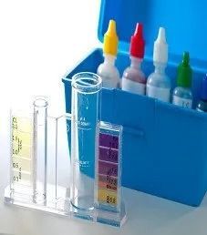 Pool water testing kit with vials, reagents, and color chart in a blue case.