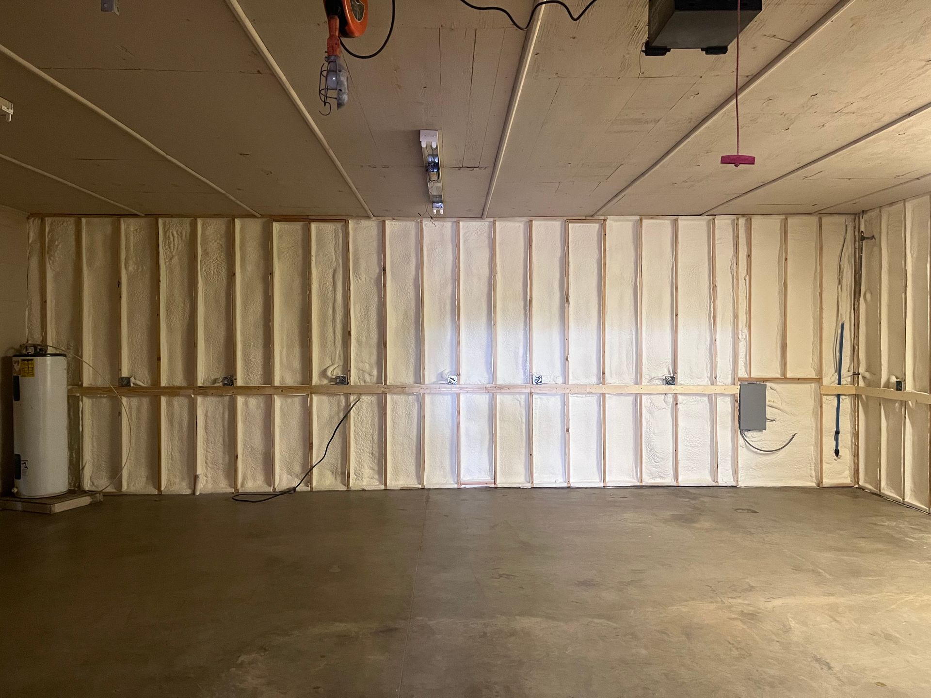 A garage with a lot of insulation on the walls and ceiling.