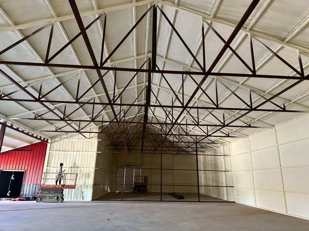 A large empty warehouse with a metal structure.