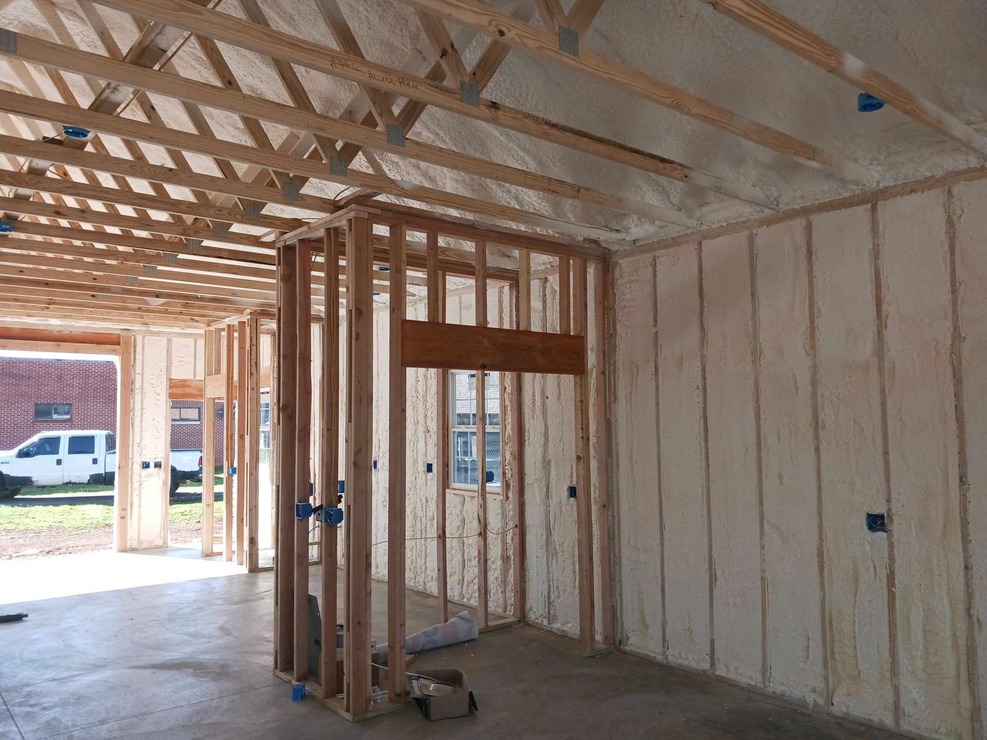 A room with a lot of wooden beams and foam on the walls.