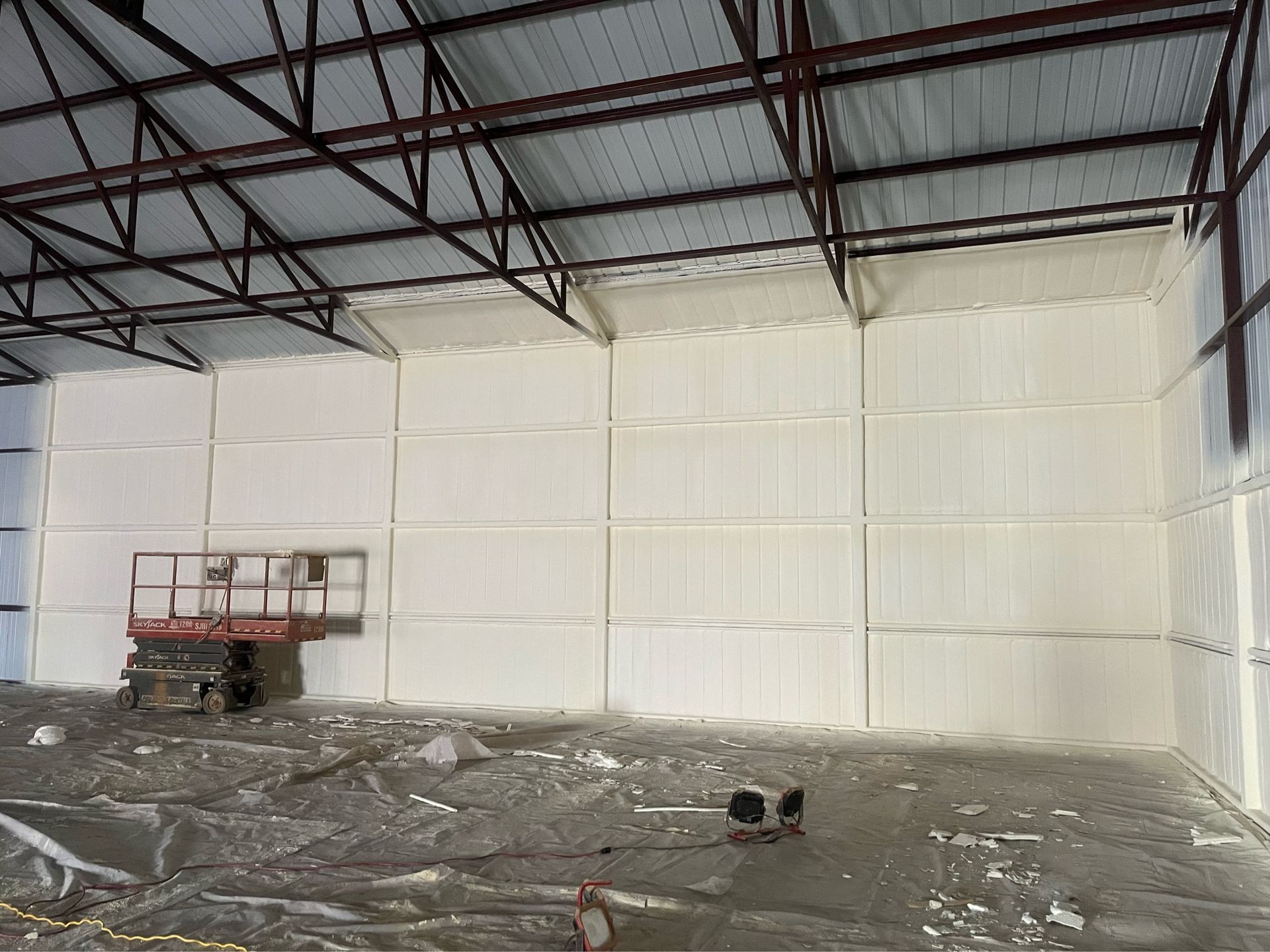 A large warehouse is being insulated with foam.
