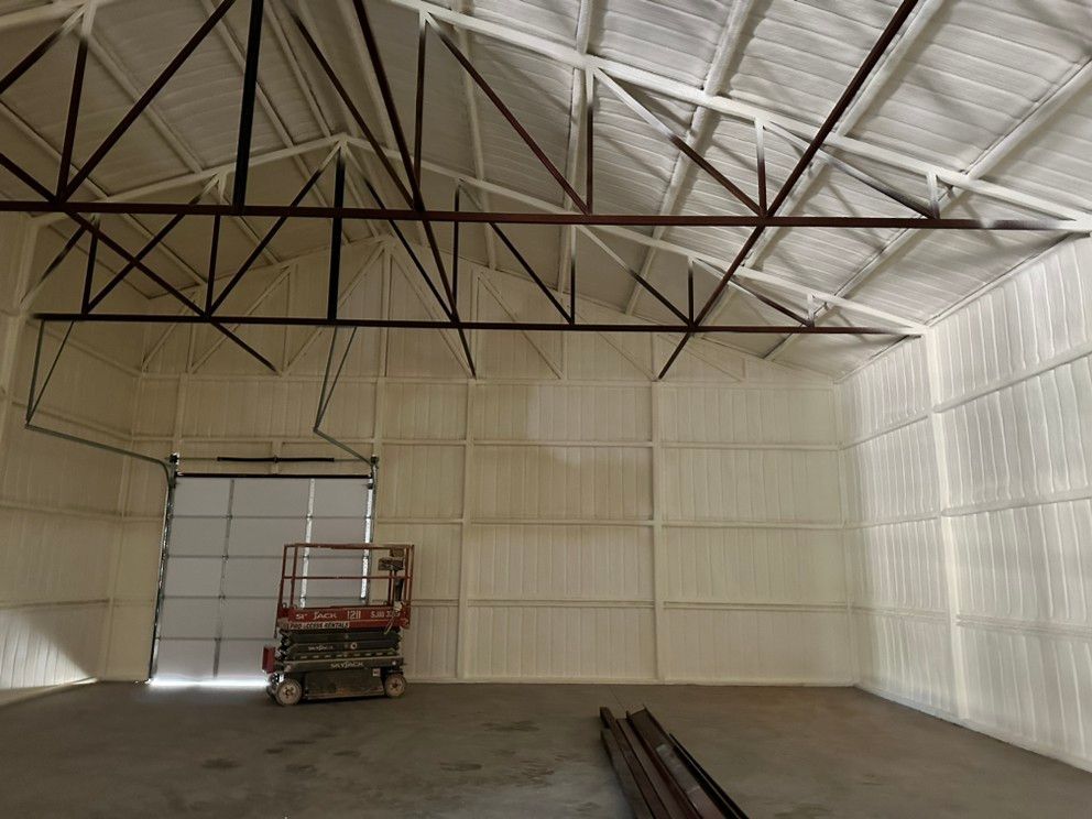 An empty warehouse with a lift in the middle of it