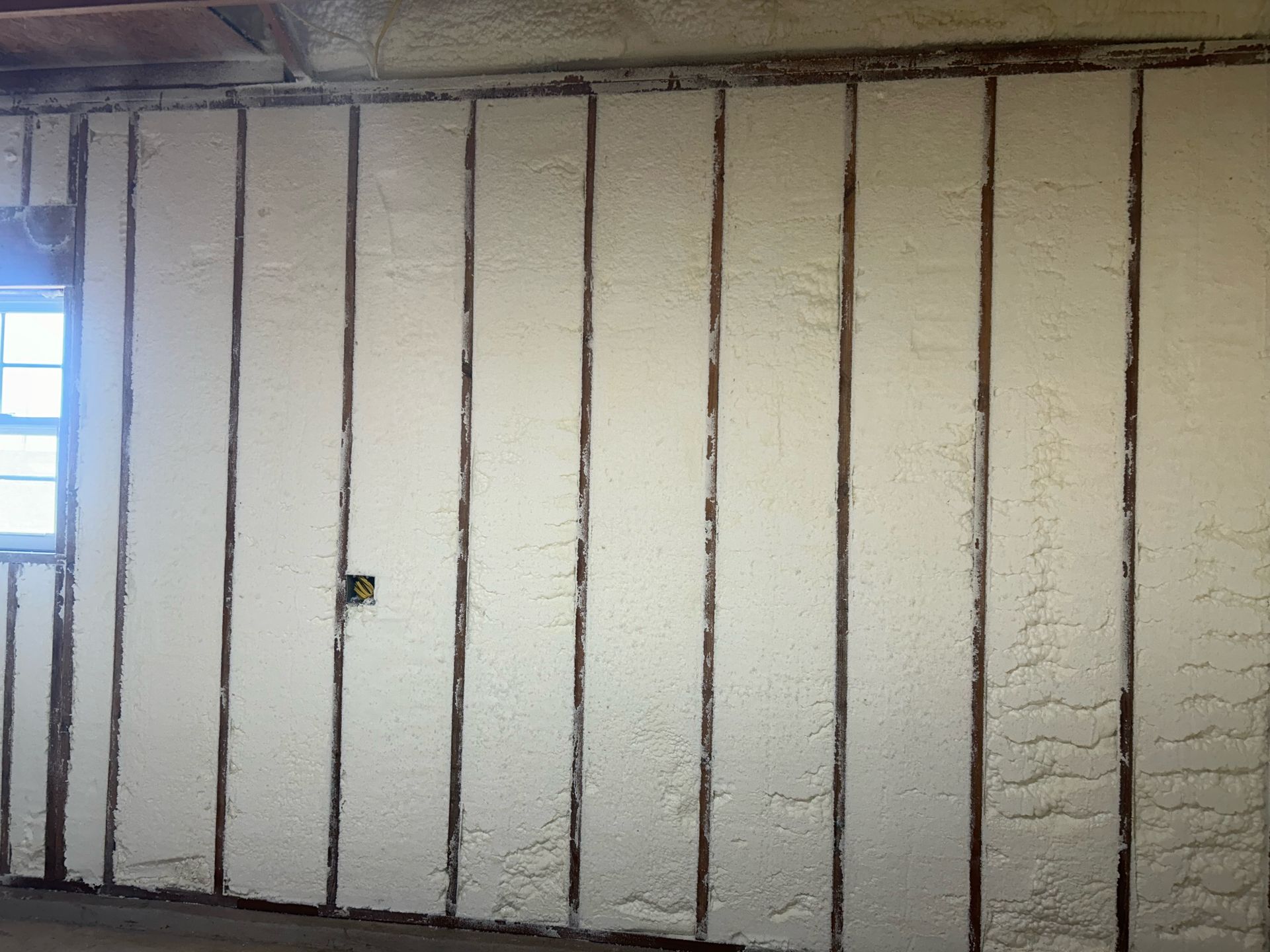 A room with a lot of foam on the walls and a window.